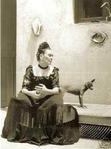 Old black and white photo of lady in dress with Mexican Hairless