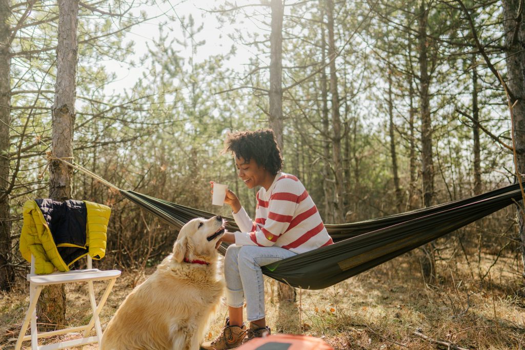 A woman camping with her dog.